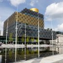 yellow-and-gray-metal-frame-glass-building-by water