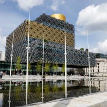 yellow-and-gray-metal-frame-glass-building-by water