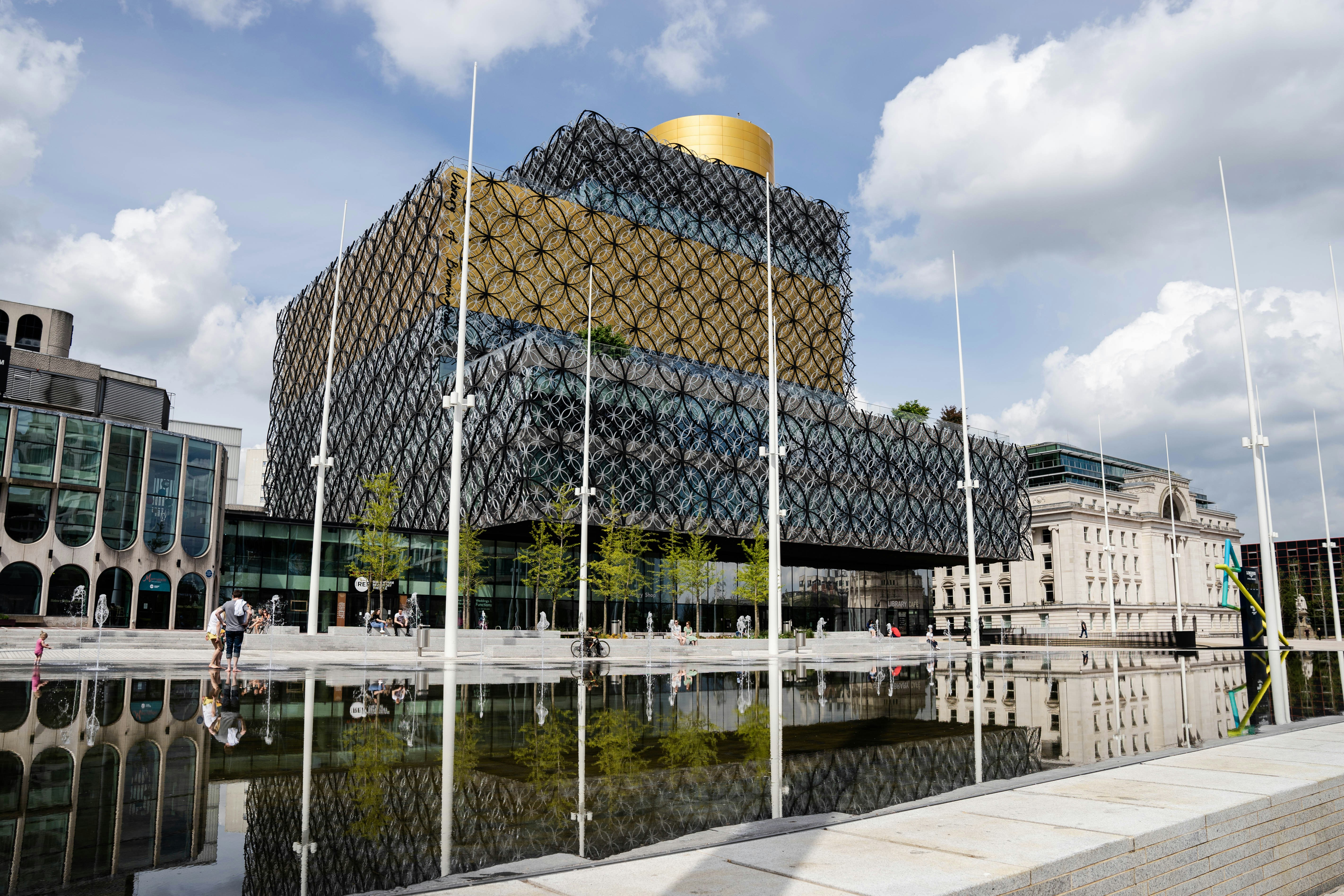 yellow-and-gray-metal-frame-glass-building-by water