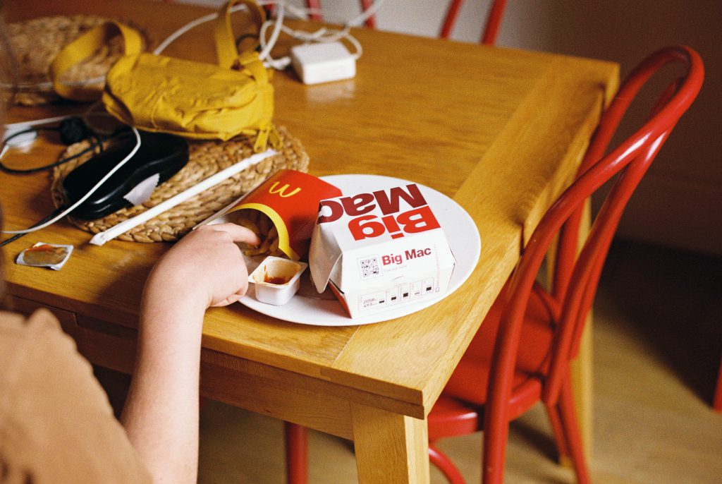 fast food on table with hand reaching for 