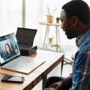 A man talking to a woman on a laptop