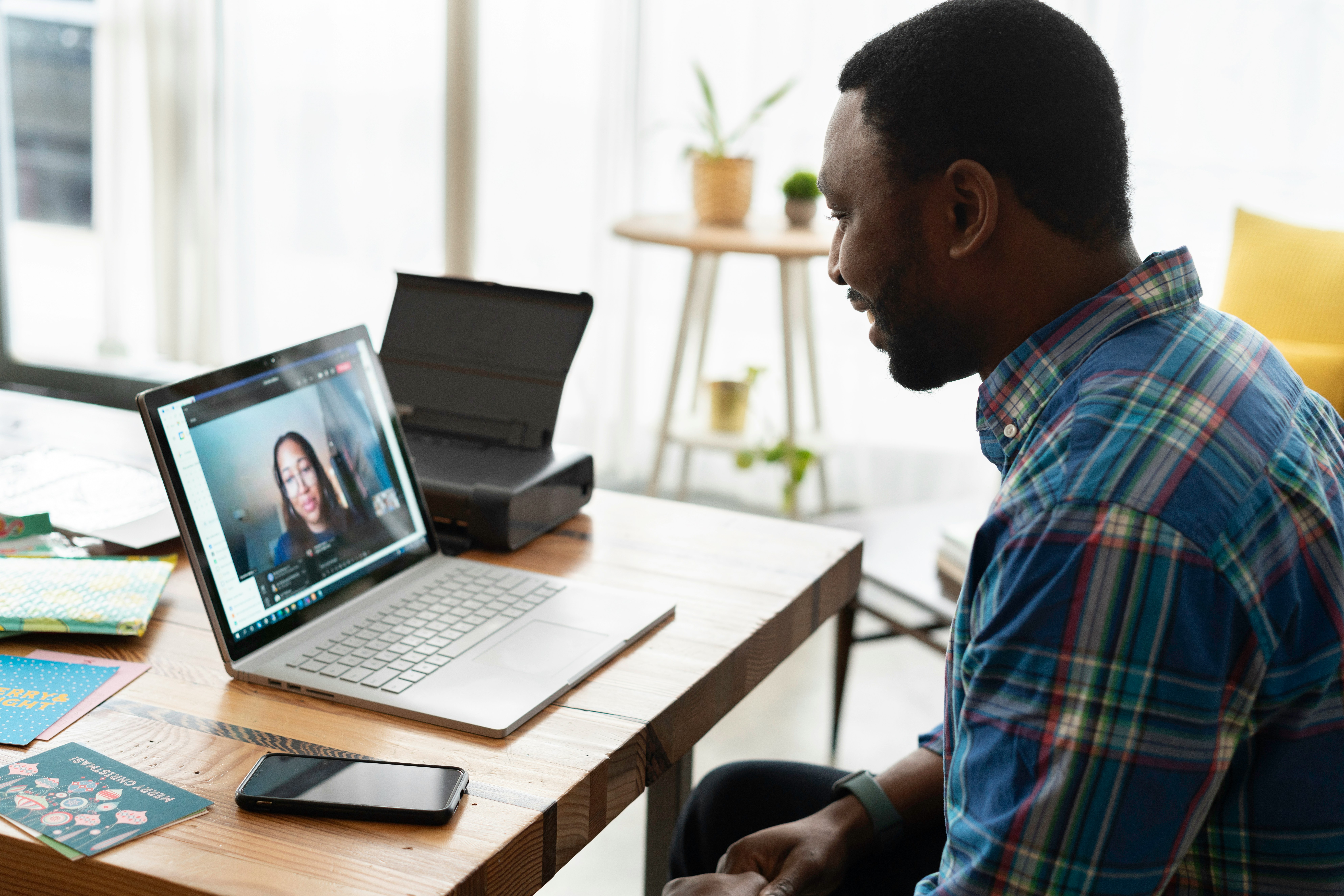 A man talking to a woman on a laptop