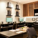 banks of desks in a room with pictures on the wall