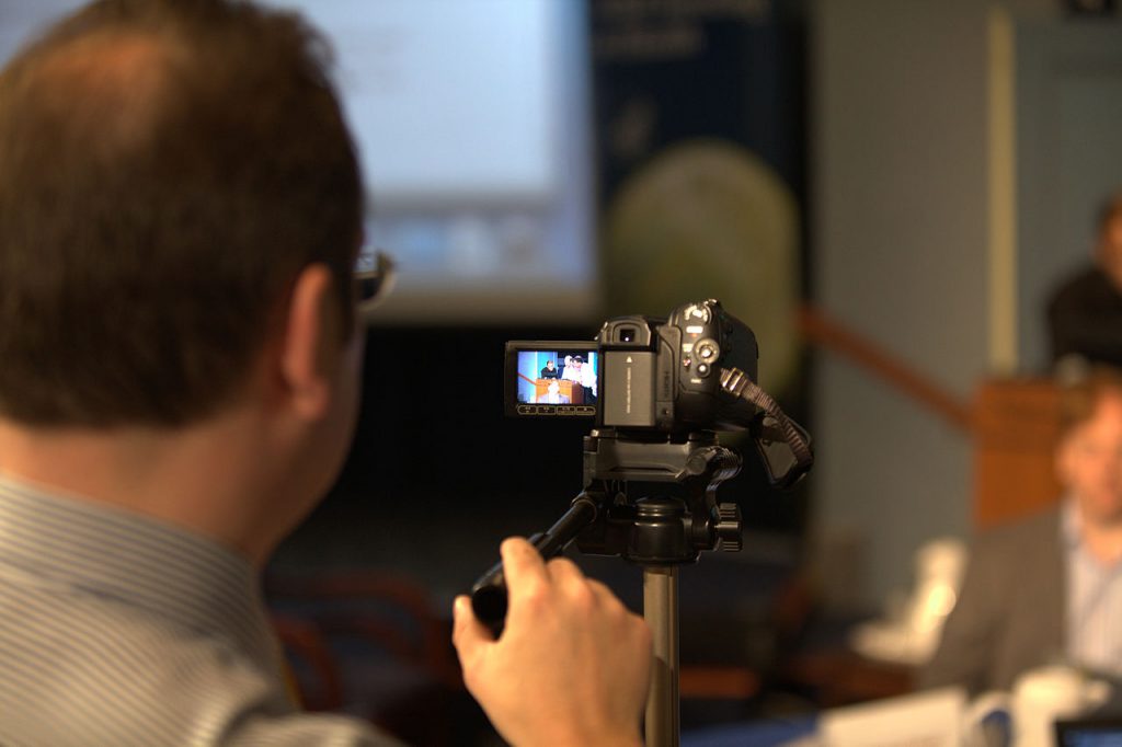 Man looking through Camcorder