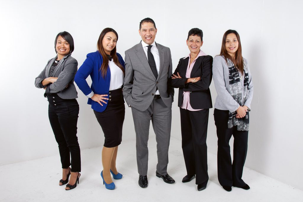 A diverse team of workers, some of whom clearly mean BUSINESS with their arms folded like that.