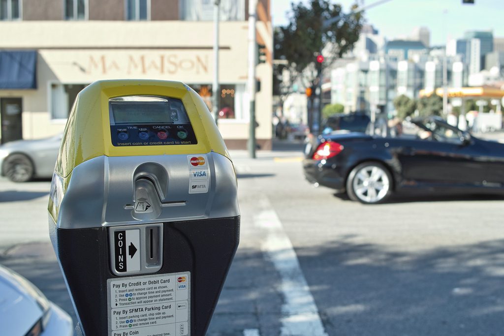 A modern parking meter in a busy shopping suburb. 