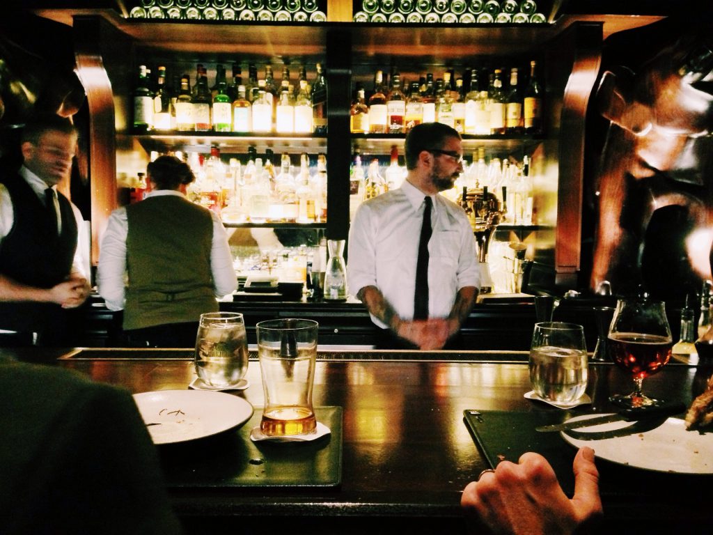 Bar staff serving drinks and food.