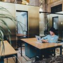 man sat at desk working on laptop