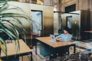 man sat at desk working on laptop