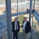 two men standing on stairs