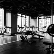 black and white image of a gym interior showing running machines