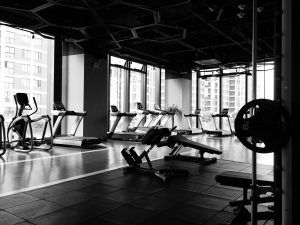 black and white image of a gym interior showing running machines