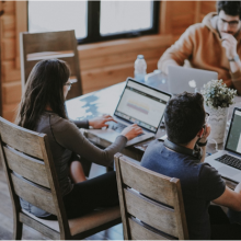 three people on laptops