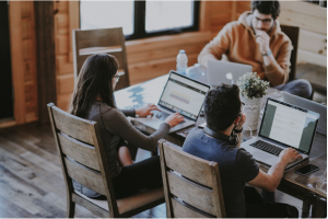 three people on laptops