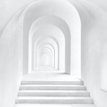 white archway in a white wall