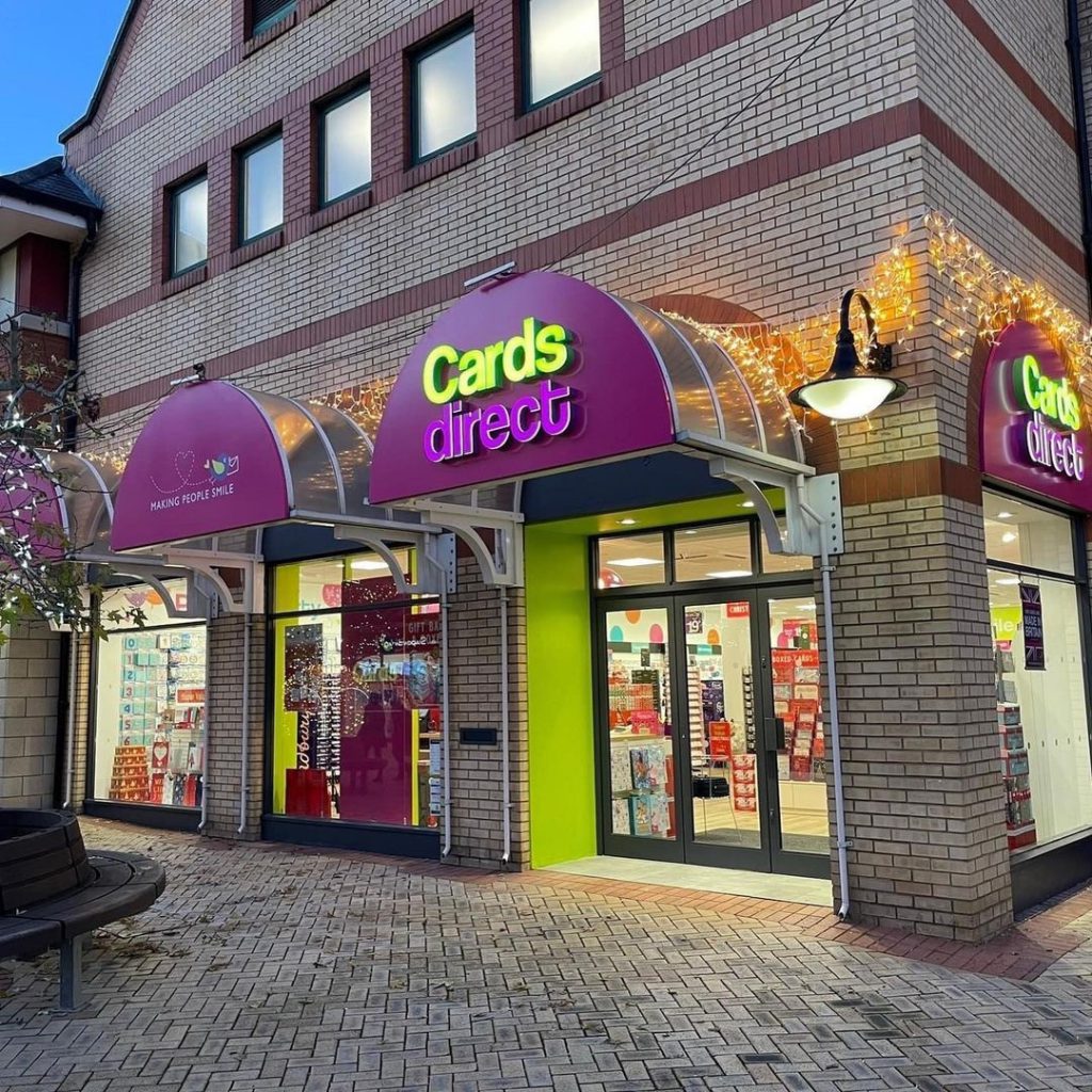 exterior retail unit with purple signs