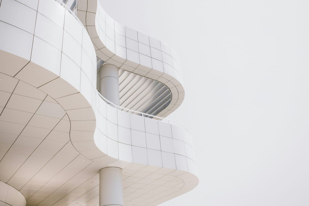 white building with curved balconies