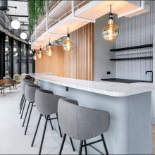 chairs round a bar style desk in an office