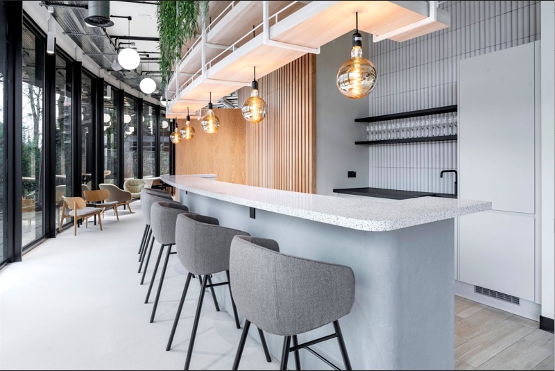 chairs round a bar style desk in an office