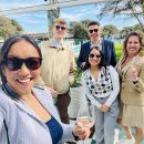 3 women and 2 men taking a selfie in the sunshine