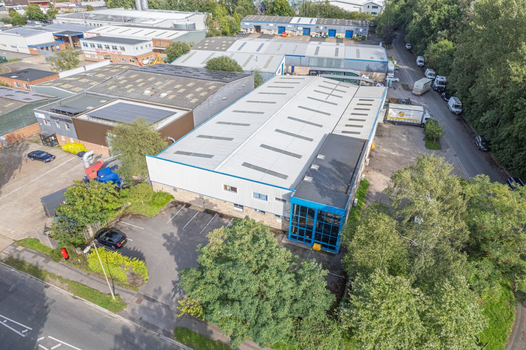 aerial view of a warehouse surrounded by trees