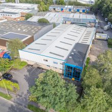 aerial view of a warehouse surrounded by trees