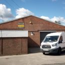 van in front of warehouse