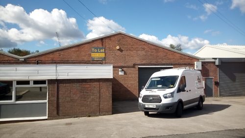 van in front of warehouse