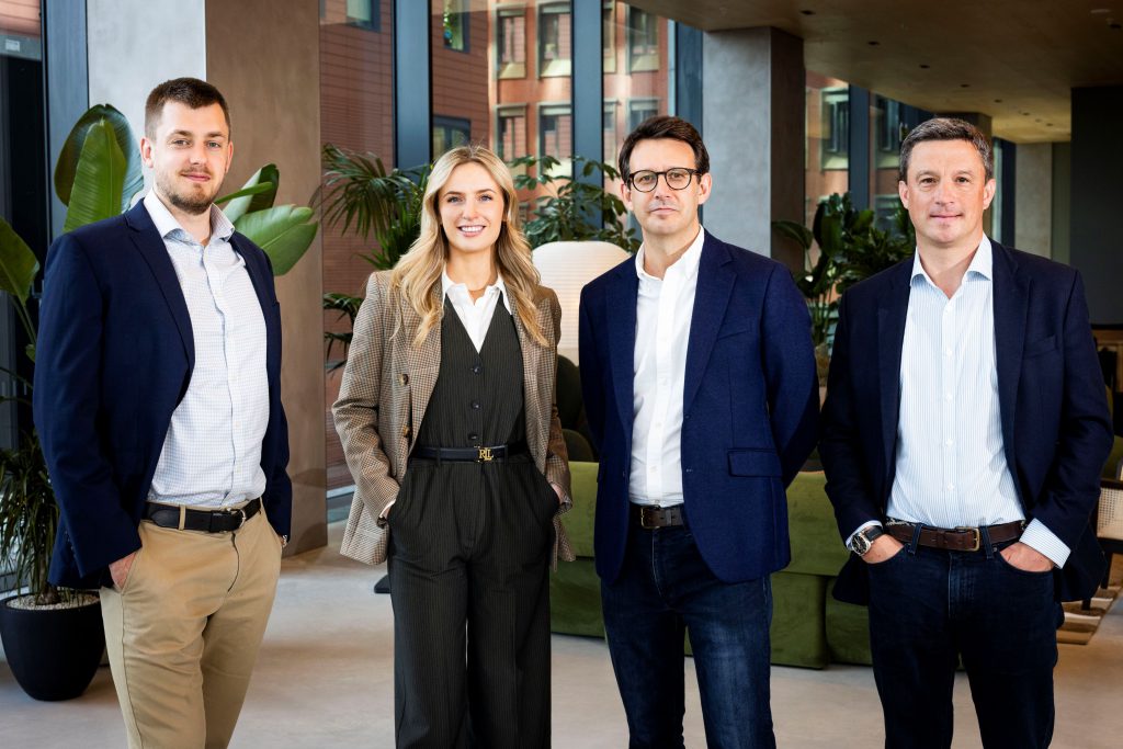 three men and one woman in business wear