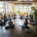 people sat in a circle in a yoga pose