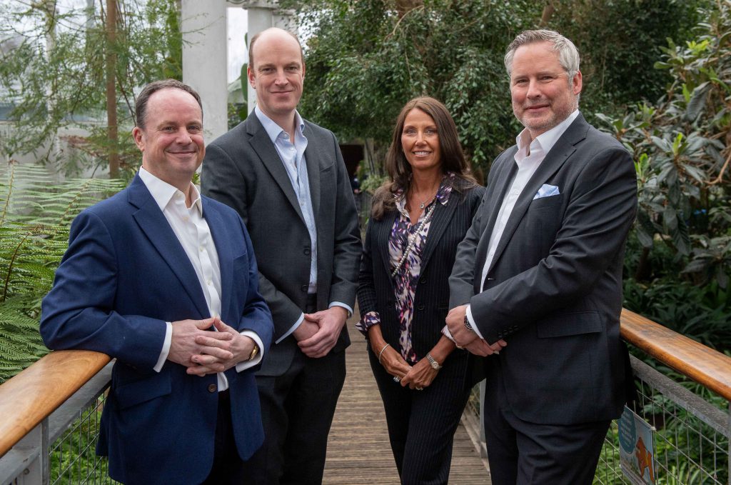 three business men and one woman 