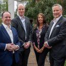 three business men and one woman