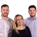 Two men and one woman posing for a photo