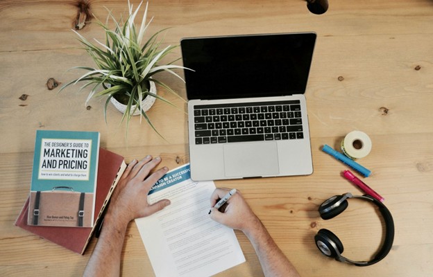overhead view if lap and person looking at marketing notes