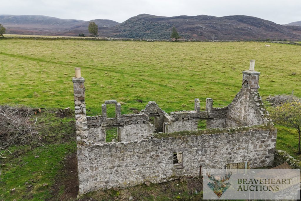 an abandoned stone building in a field