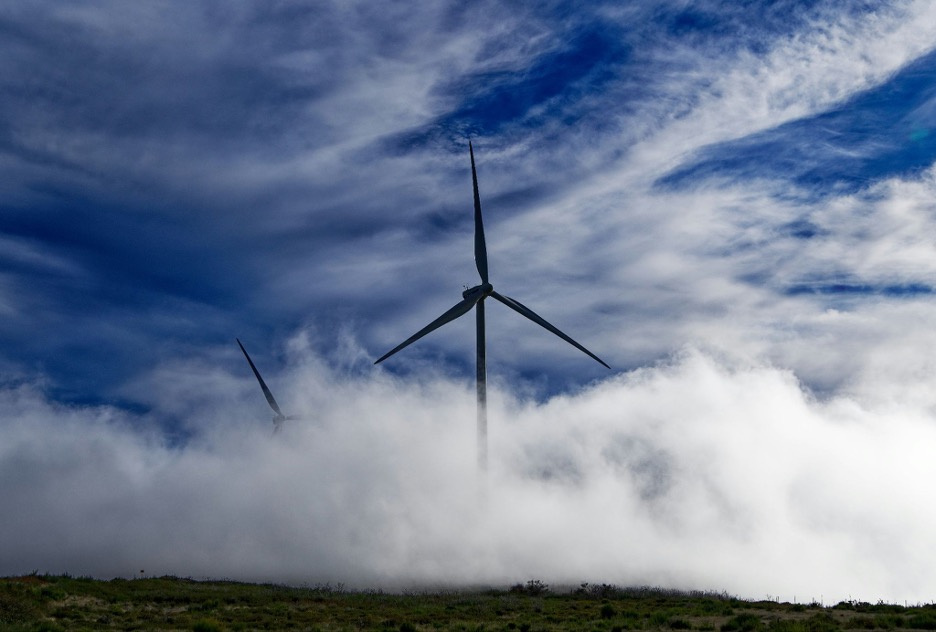 Wind turbine surrounded by clouds