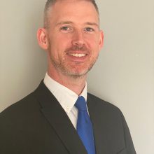 Head and shoulders photo of man in a business suit