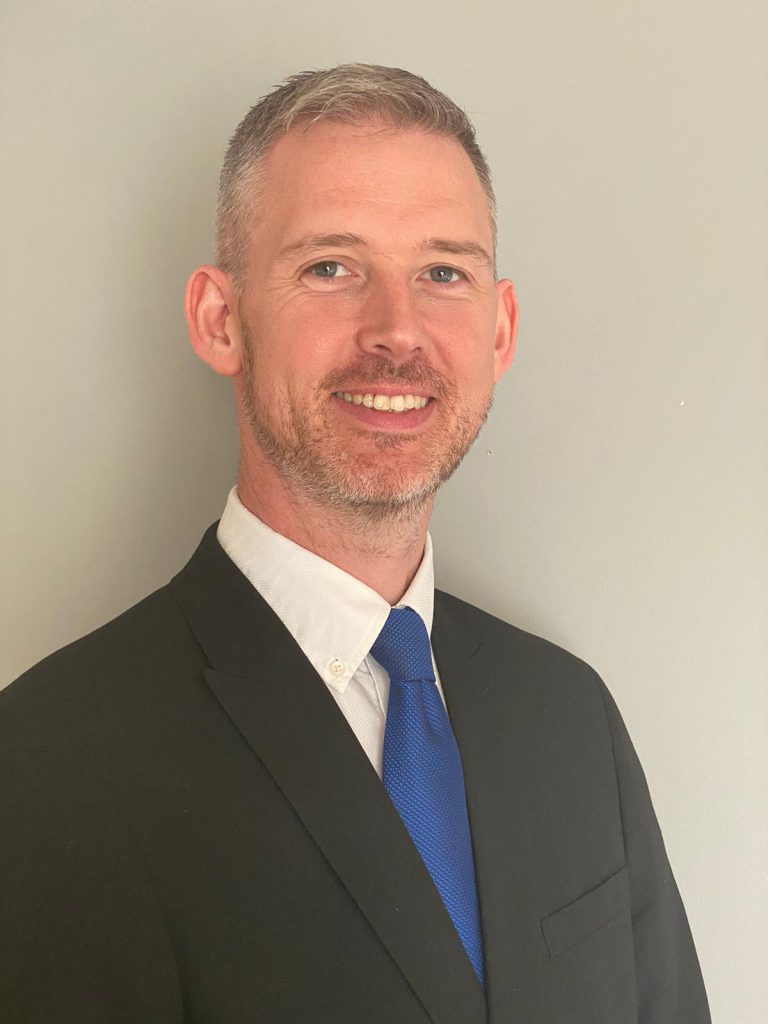 Head and shoulders photo of man in a business suit