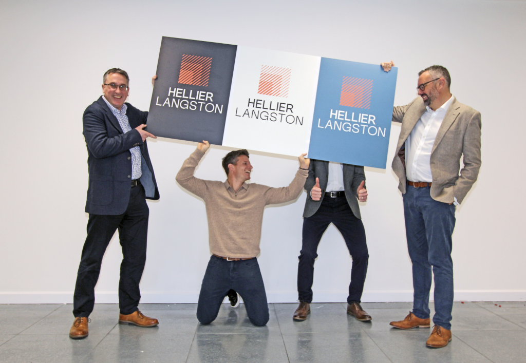 four men holding up logo's