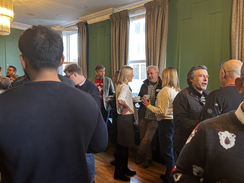 a group of people chatting in a room