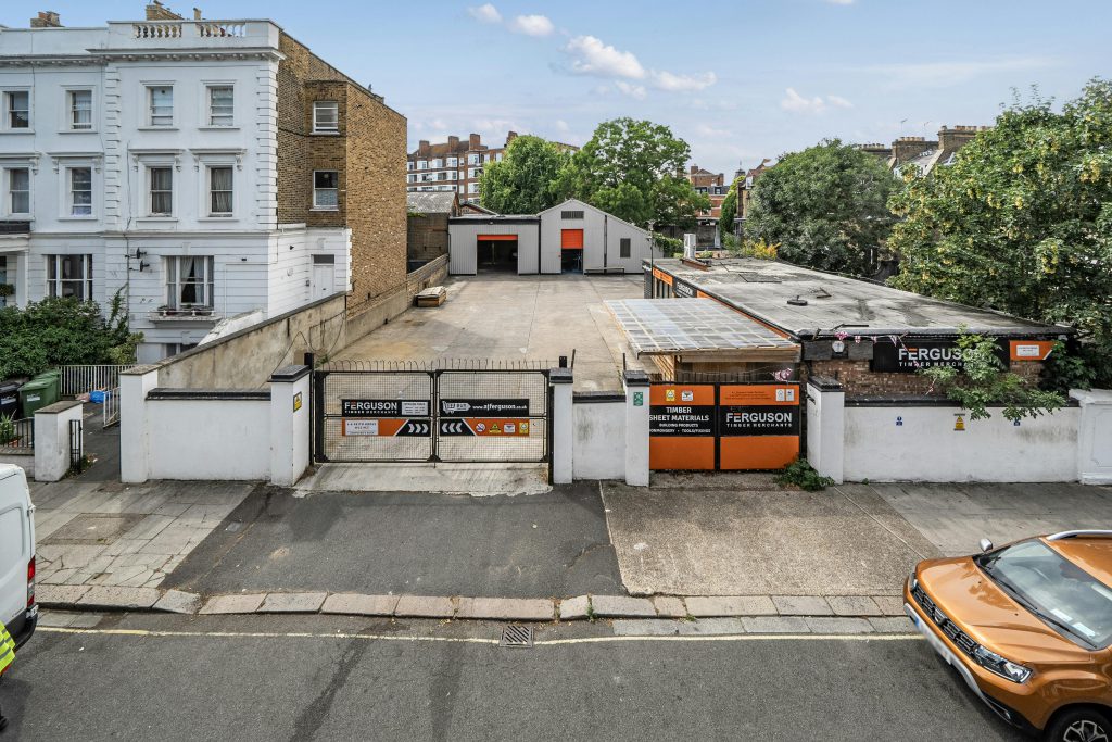 yard area with building at rear.