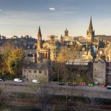 A view of a city with a train track in the foreground