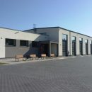 Industrial unit exterior with seating by an entrance doo