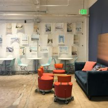 studio space with furniture and images on the wall