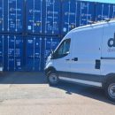DBS van in front of storage containers