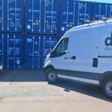DBS van in front of storage containers