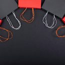 black and red shopping bags lying in a semi circle