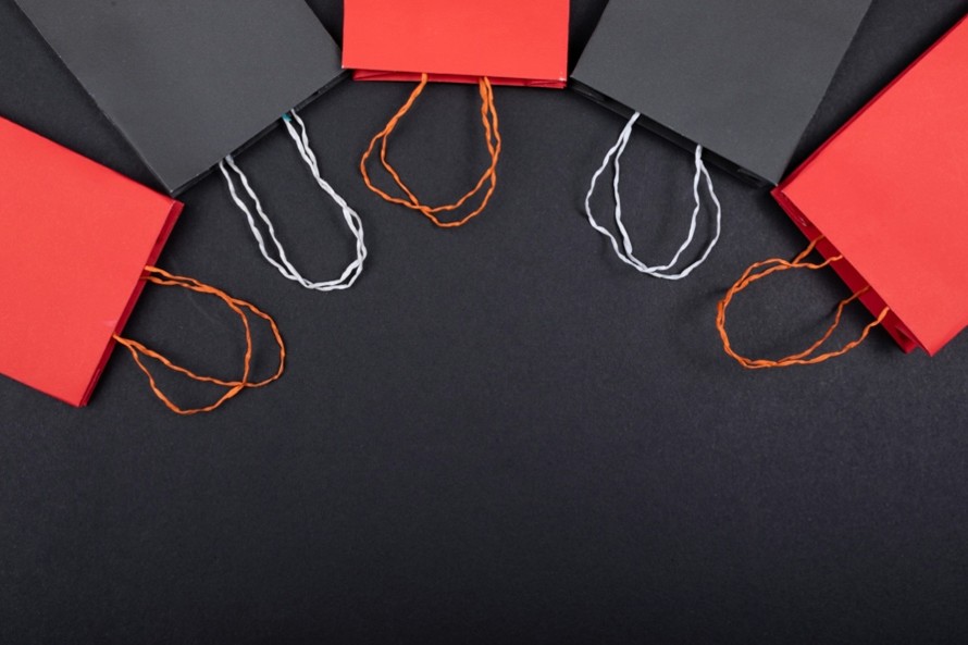 black and red shopping bags lying in a semi circle