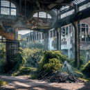 ghostly figures among a ruined industrial unit